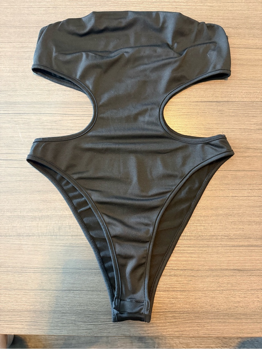 Sleek Black Cutout Bodysuit with High-Cut Leg